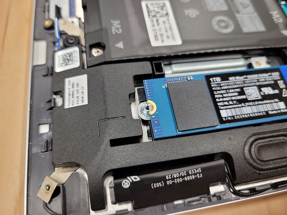 Install the SSD by pressing the contacts into the holder at a 30 degree angle, then press down the other side onto the bracket.