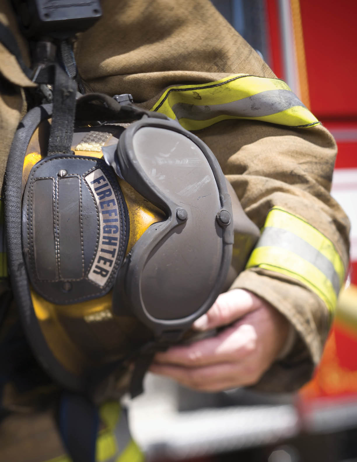 Close-up of a firefighter holding a firefighter s helmet 