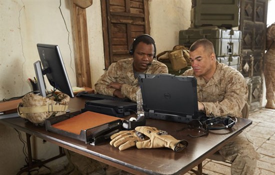  Two military personnel sit at table with Dell Rugged laptops