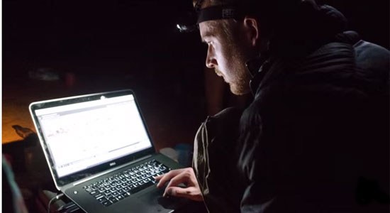 Martin Edström works on a Dell laptop inside Son Doong Cave