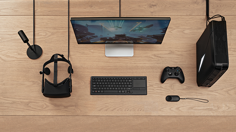Dell monitor and keyboard with Oculus headset on desk