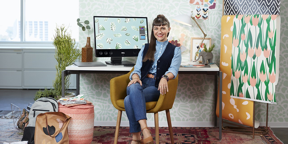 Artist and wallpaper designer Kathryn Zaremba sitting in her studio