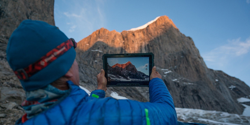 Mike Libecki uses a Dell Rugged Latitude tablet to take a photo of a mountain