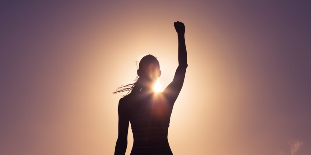 woman standing with fist raised