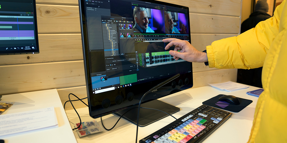 person using touch screen on Dell Precision AIO to edit video