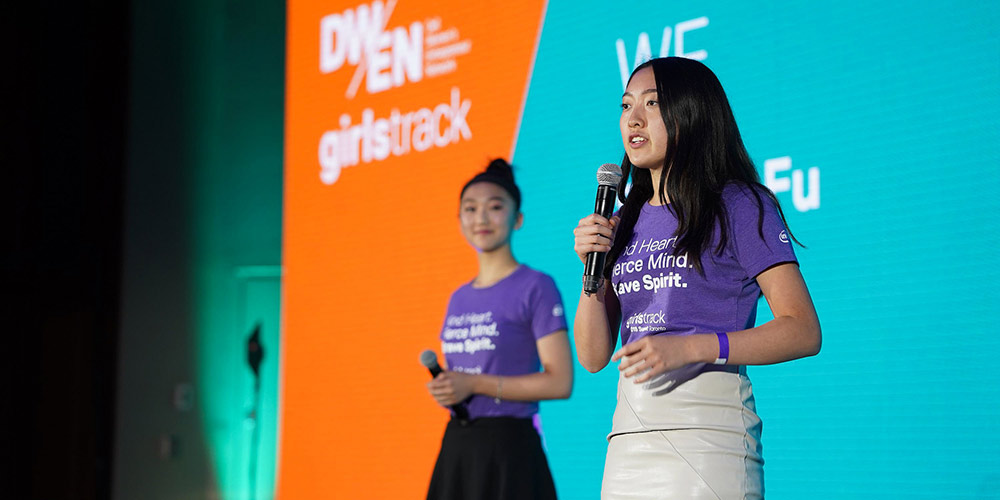 photo of two girls speaking on stage at Dell Women's Entrepreneur Network (DWEN) Summit 2018