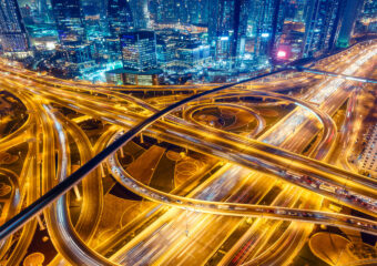 Highways instersecting in city environment at night, with lights from road traffic. .