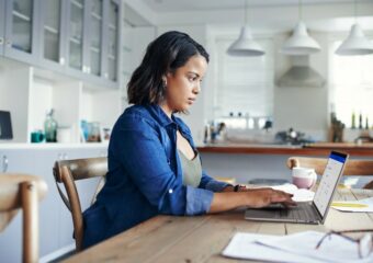 Woman working from home in her dining room.