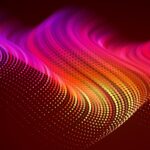 Abstract digital image of wave format in orange, red, and pink hues.