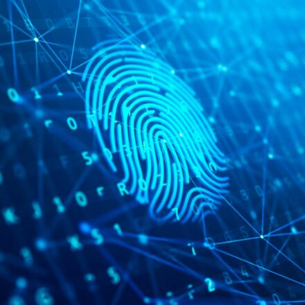 Scanned fingerprint against a digital background, representing biometric security.