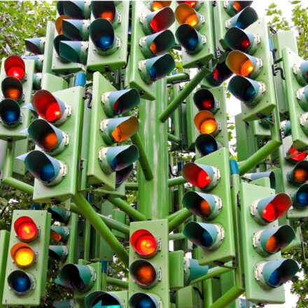 Numerous traffic lights in one location.