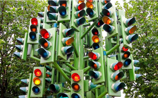 Numerous traffic lights in one location.