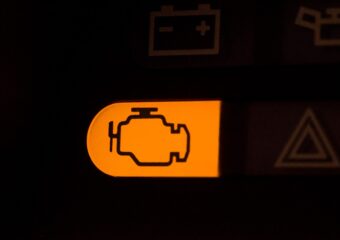 Orange check engine light alert appearing on a car's dashboard.