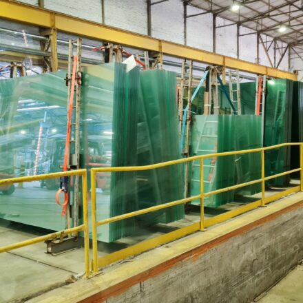 Glass panels and panes of various sizes and thickness levels at a glass manufacturing facility.