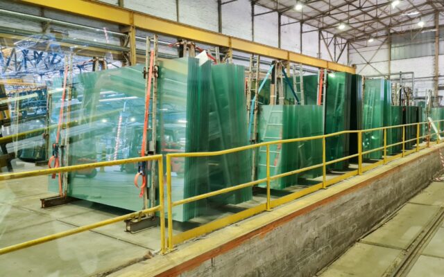 Glass panels and panes of various sizes and thickness levels at a glass manufacturing facility.