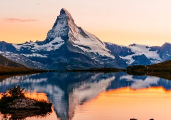 The Matterhorn mountain in the Swiss Alps, with reflection on a nearby lake.
