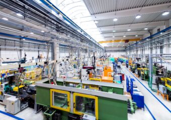 Interior of a plastics fabrication plant utilizing robotics and smart factory technology.