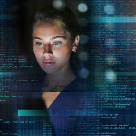 Young woman coding, with digital overlay of programming code superimposed around her.