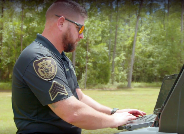 Member of the Baker County, Florida Sheriff's Department accessing information in the field using a Dell laptop. 