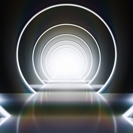 3D rendering of concentric rings in neon white light, similar to walking into a tunnel or portal.