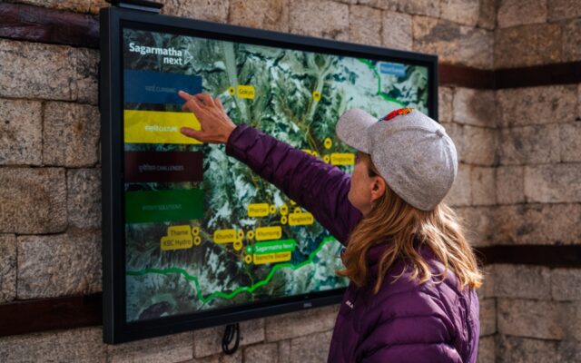Visitor in the Sagarmatha Next Centre explores park and center information on a Dell interactive touch monitor. Photo credit by Martin Edstrom.