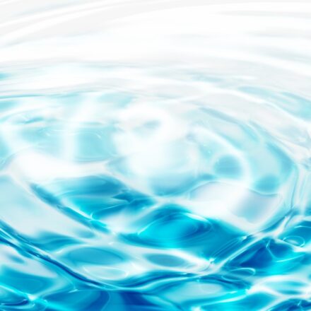 Water rippling in concentric circles against a turquoise blue background.