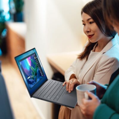 TWo women looking at a Dell Pro Max 14 premium laptop