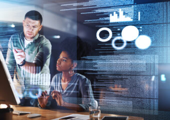 Shot of two programmers working together on a computer code at night. AI Security Best Practices