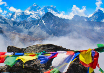 Picturesque view of great Himalayan panorama with Everest and Lhotse dominating the horizon with prayer flags in foreground seen from top of Gokyo Ri in Nepal