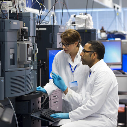 Dell PowerEdge for AI research. Scientists in a laboratory recording data. Both working beside a special piece of machinery called a Mass spectrometry (MS) , an analytical chemistry technique that helps identify the amount and type of chemicals present in a sample by measuring the mass-to-charge ratio and abundance of gas-phase ions