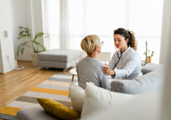 AI PC Refresh image representing mobile healthcare, female doctor treating an older female patient.