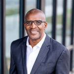 Kevin Brown, Dell Technologies Executive Vice President of Global Operations & Chief Supply Chain Officer, wearing a white button-down shirt and a navy blazer.
